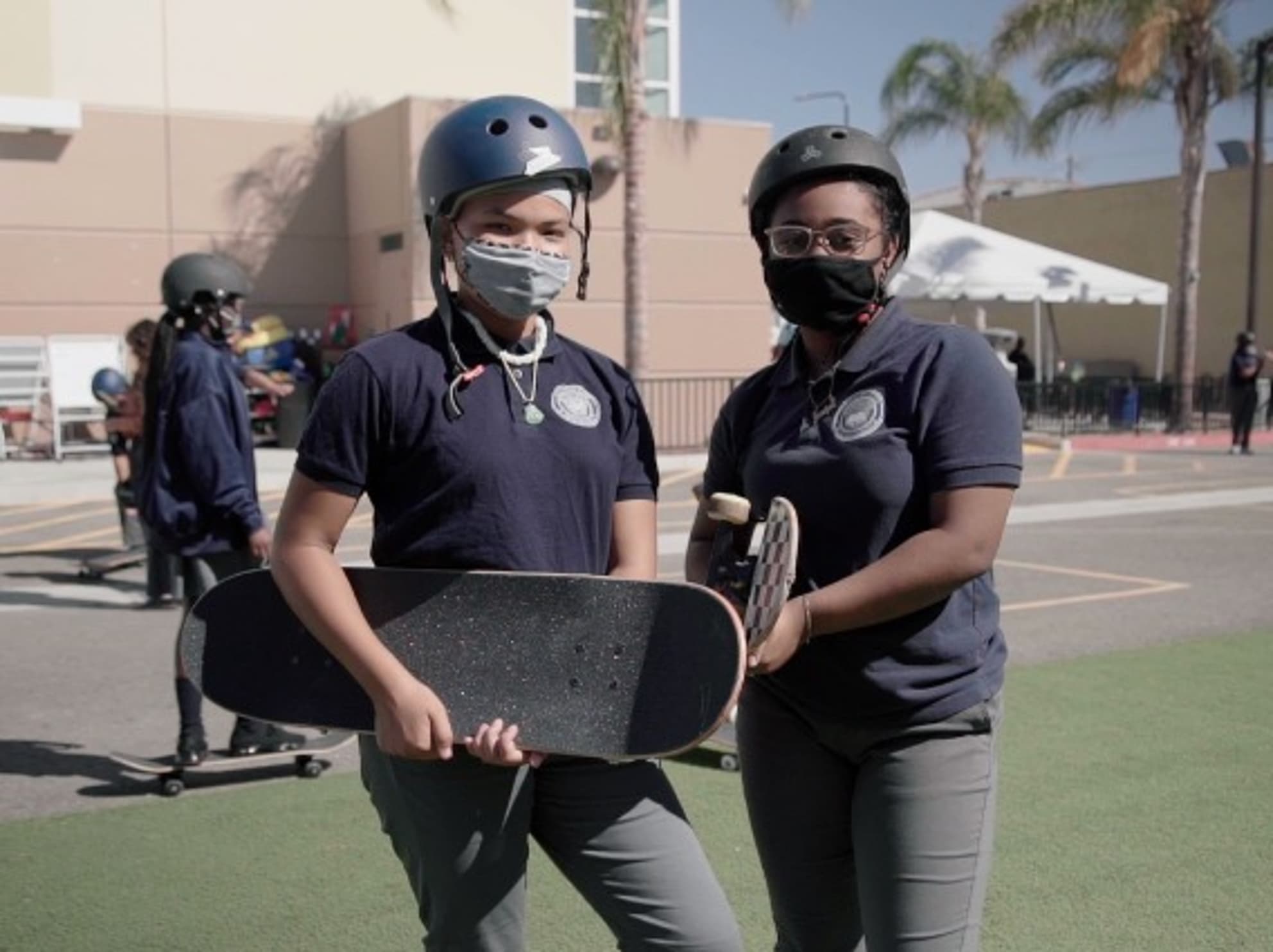 Two ICEF students holding skateboards